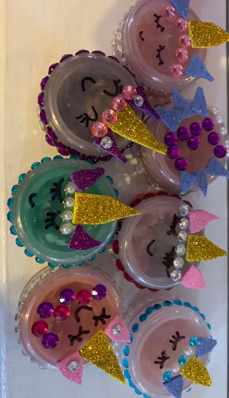 Handmade lip balm pots decorated with gems and unicorn designs