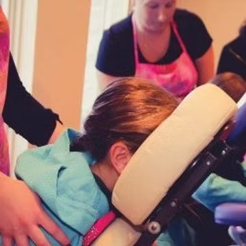 Child getting a relaxing chair massage
