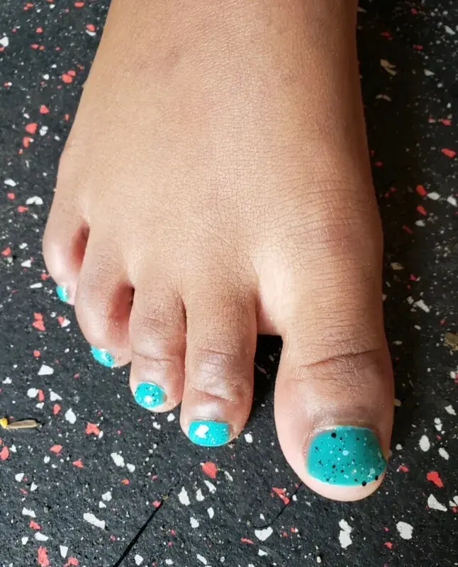 Child enjoying a SPAH pedicure in a robe